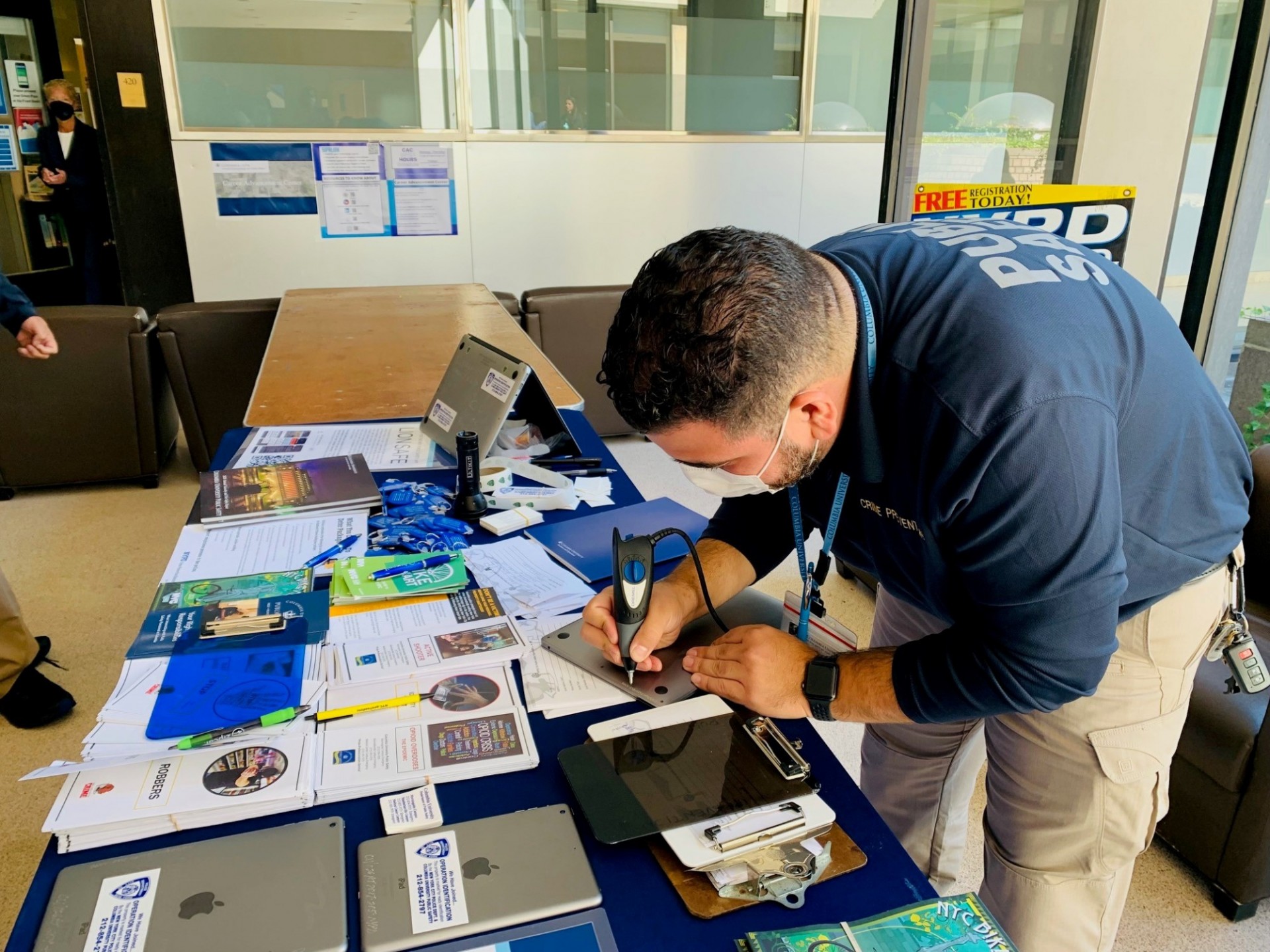 The Public Safety Crime Prevention Unit administers several important programs for community members, offering education on personal safety and tools for preventing theft. Public Safety team member engraving an iPad on a