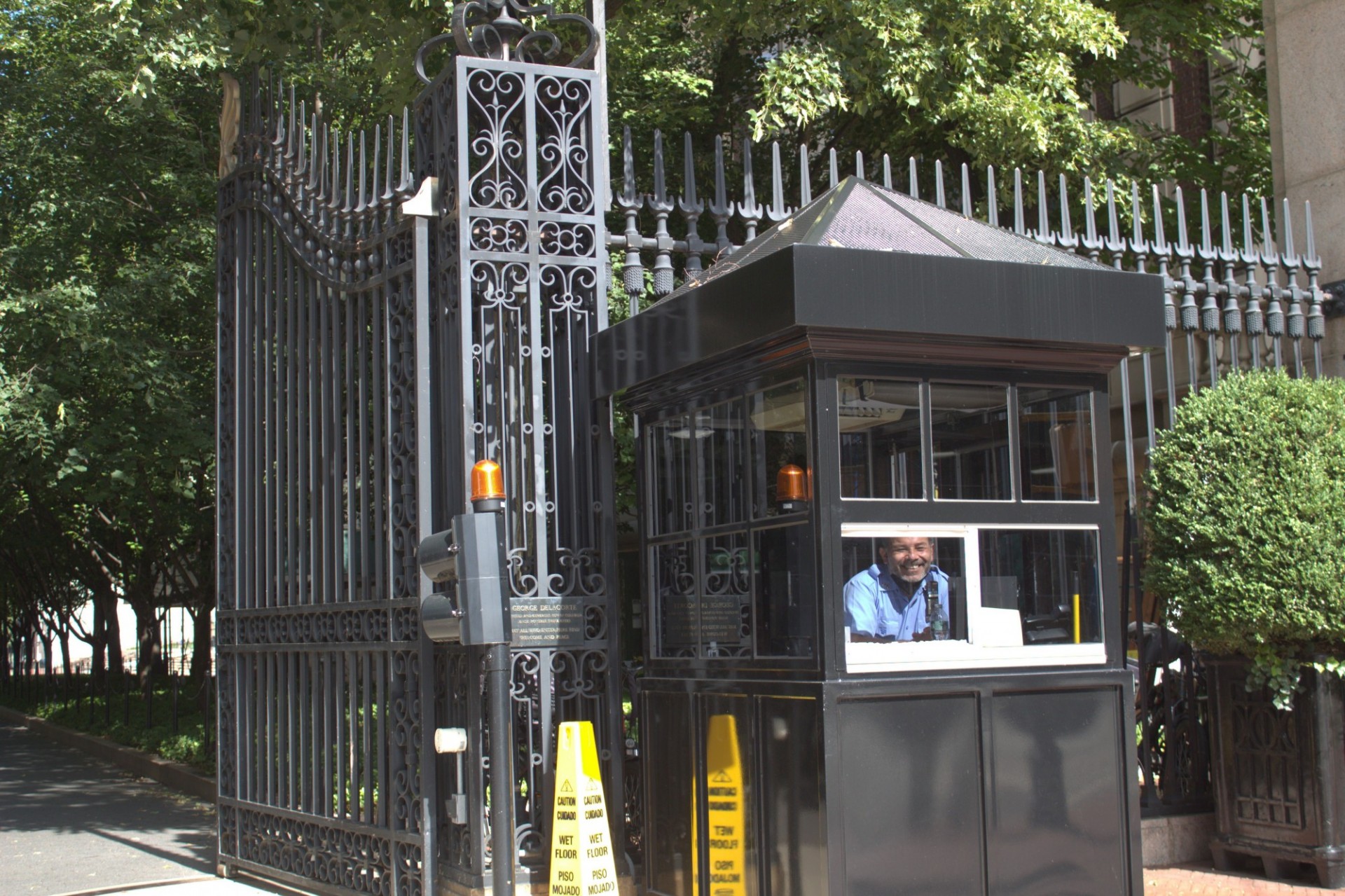 Public Safety officers often serve as ambassadors to campus, welcoming visitors as they enter and helping with directions or other assistance for anyone who asks. PSO posing for a photo while sitting in guard booth on 116th Street and Broadway.