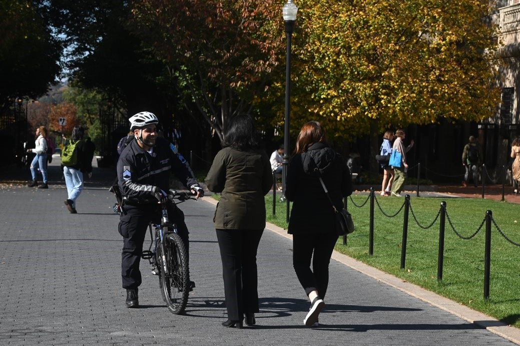 PSO Officer on Bike Patrol speaking with community members on College Walk.