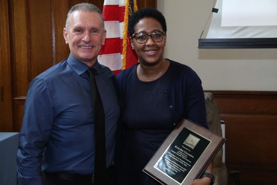 Associate Director of Finance and Administration presents Kenesha Giocastro from University Leave Management with an exceptional service award. Anthony Trabucco and Kenesha Giastro