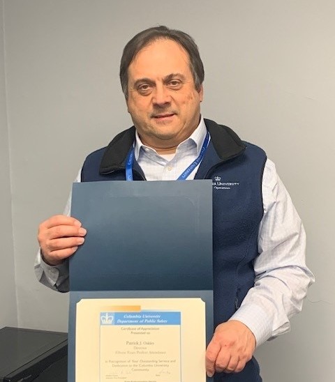 Director of Public Safety Operations Patrick Oakley Celebrates 15 Years of Perfect Attendance and Recent Promotion to Director photo of man holding up perfect attendance certificate
