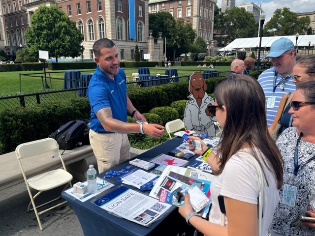 PSO officer providing crime prevention information to new students and parents during Welcome Week