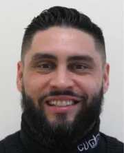 Portrait photo of officer in front of white wall