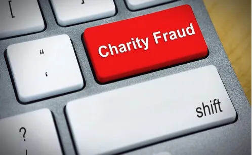 red keyboard button with text: "Charity Fraud"