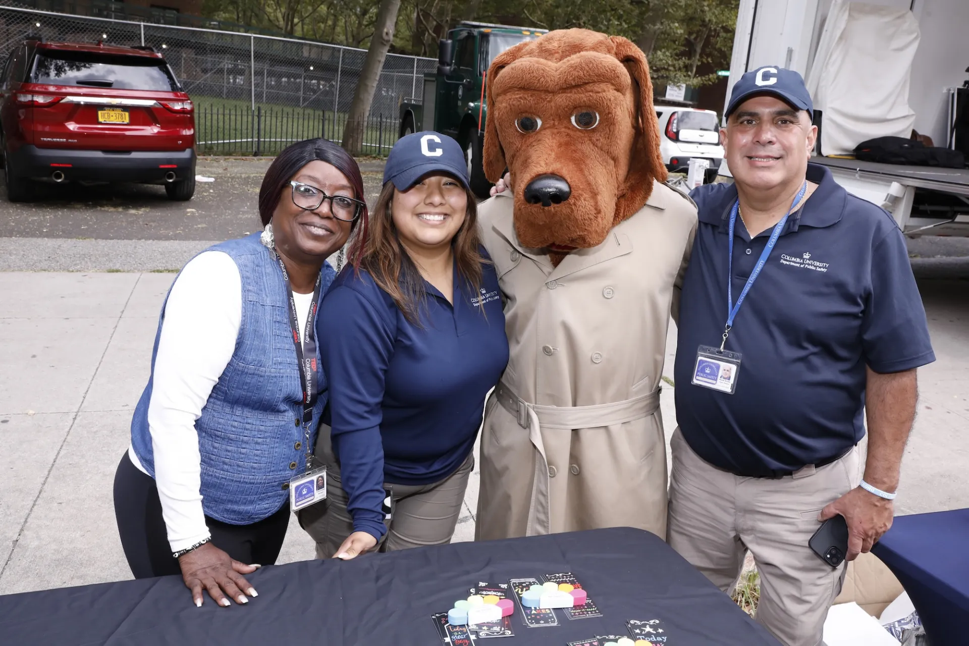 Photo by Michael DiVito. Three Public Safety staff members pose with McGruff the Crime Dog at the 10th Annual Back-2-School event.