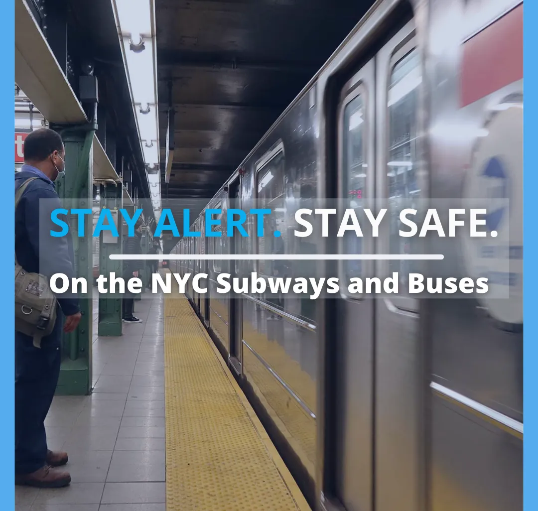 photo of man standing on MTA subway platform while train passes by